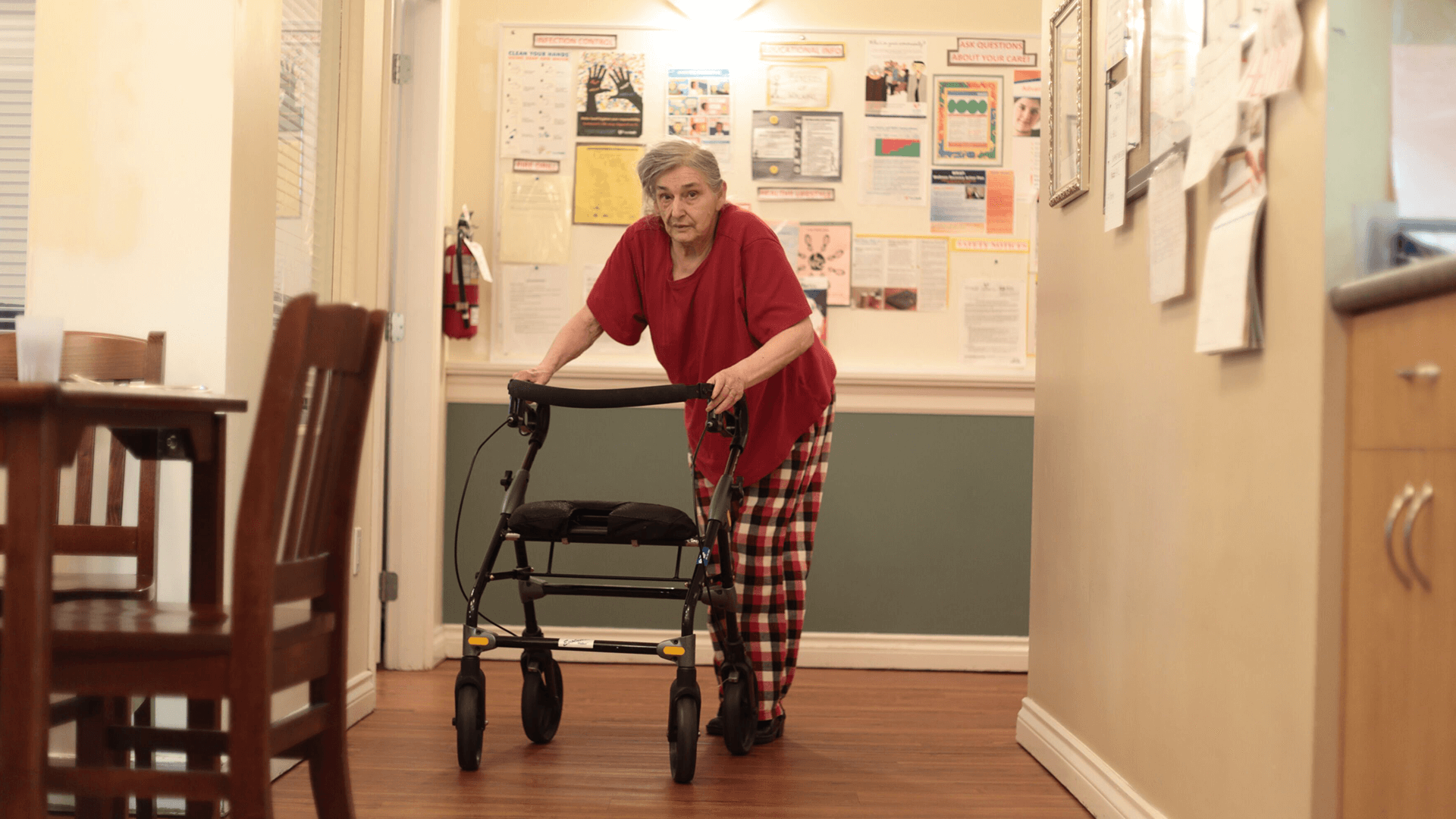 An elderly woman walking in corridors at WM